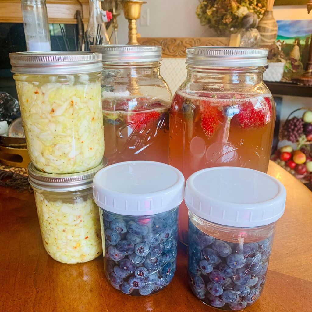 Fermentation happening today in the kitchen. Homemade sauerkraut, fermented blueberries and Water Kiefer steeped with local Oregon blueberries and strawberries. Fermentation is so good for you! Go to www.yumsofresh.com for more fermentation recipes. #fermentedfoods #saurkraut #waterkefir #healthygut #oregon #witchyfood